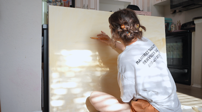 Avery sketching on washed canvas