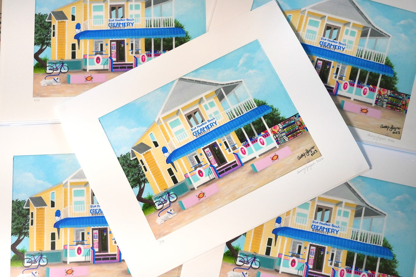 Collection of prints featuring a colorful building with a blue awning.