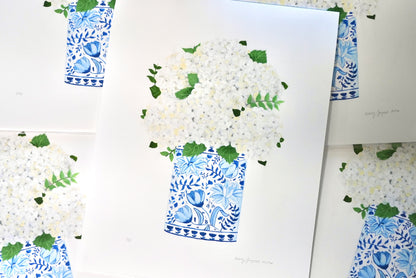 Art print of white flowers in a blue and white vase on a white background