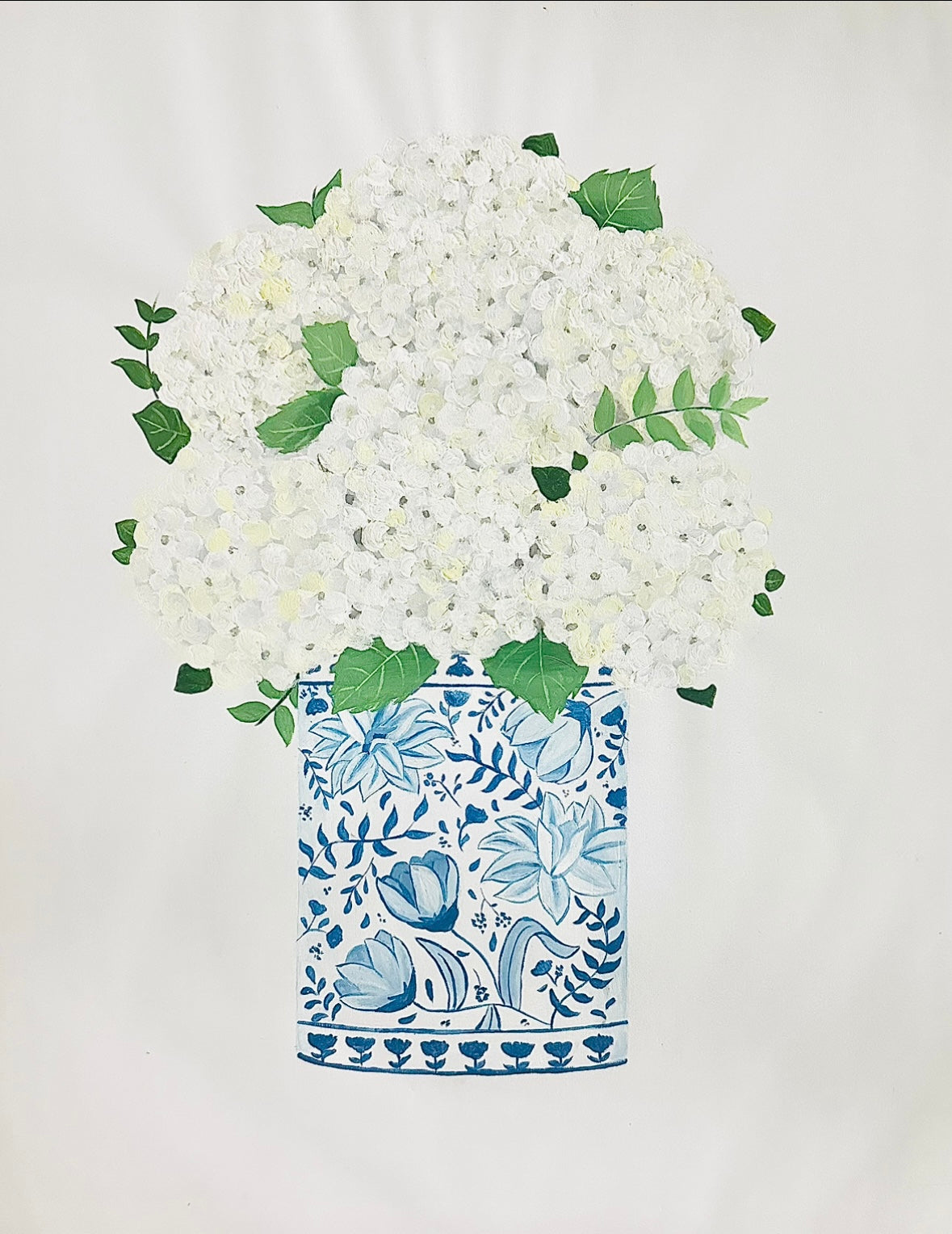 White flowers in a blue and white patterned vase on a light background