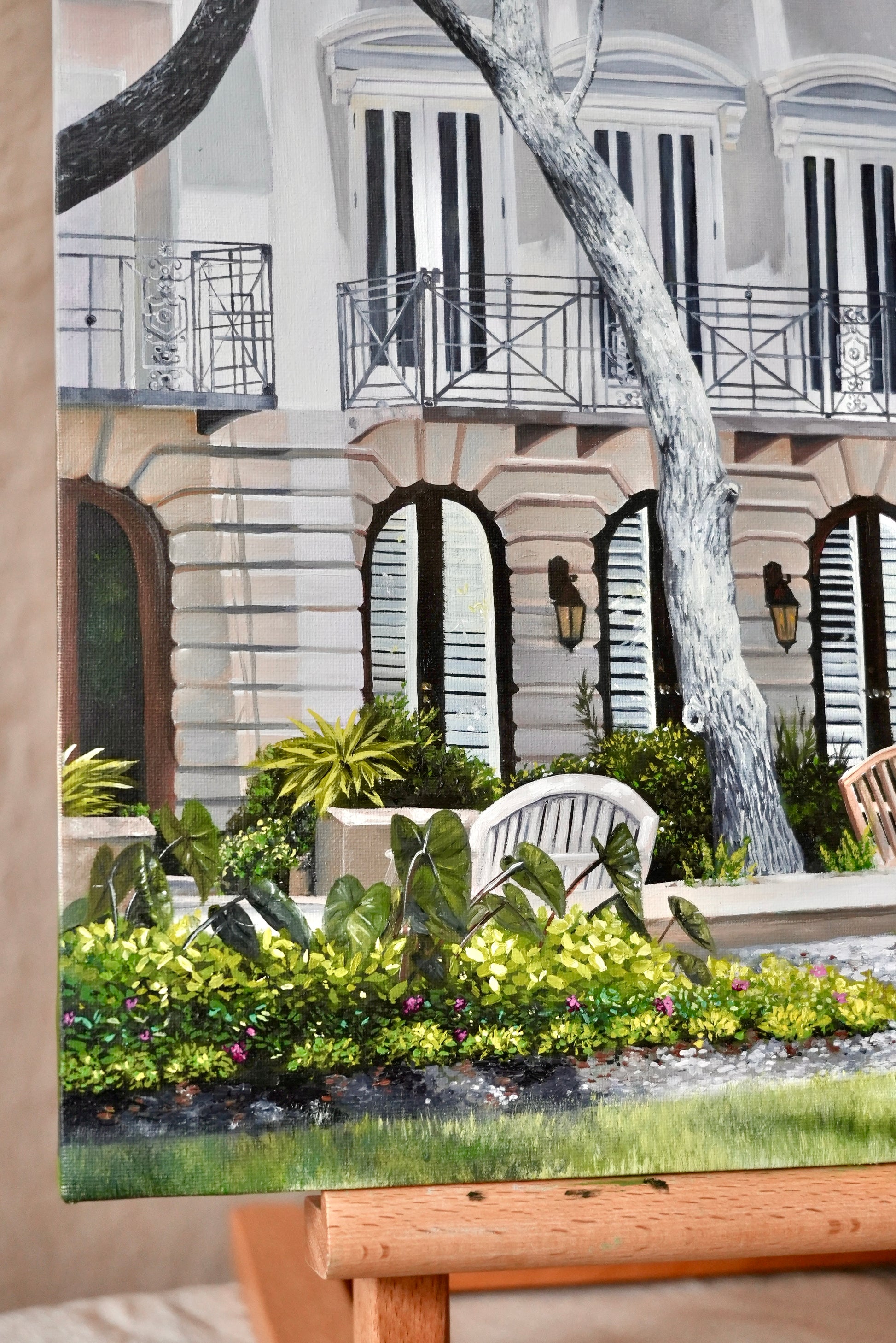 Decorative painting of a garden scene with a building in the background