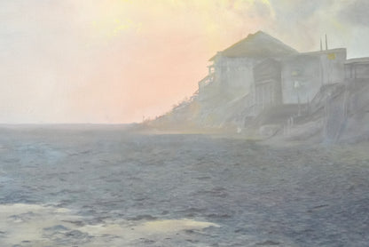 Foggy coastal scene with a building partially obscured by mist