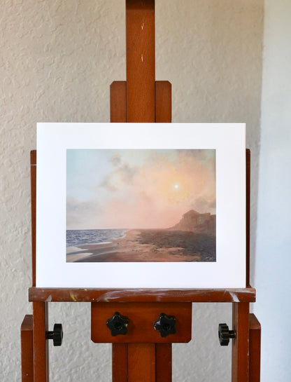 Art Print of a beach scene on a wooden easel against a white wall.