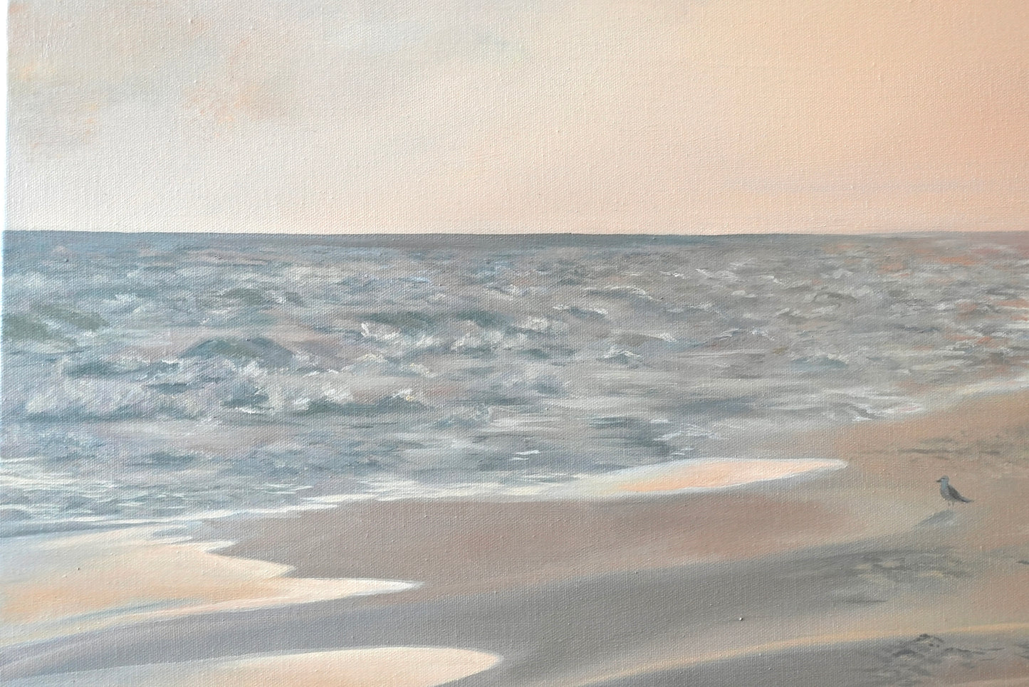 Beach scene with sand and water under a cloudy sky