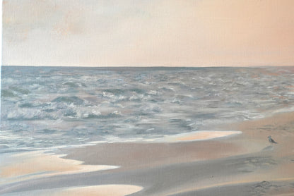 Beach scene with sand and water under a cloudy sky