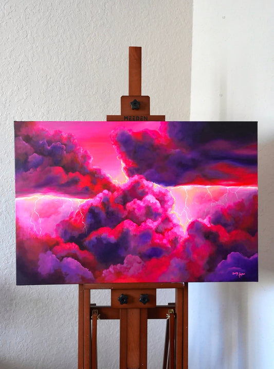 Colorful pink storm painting on an easel against a white wall