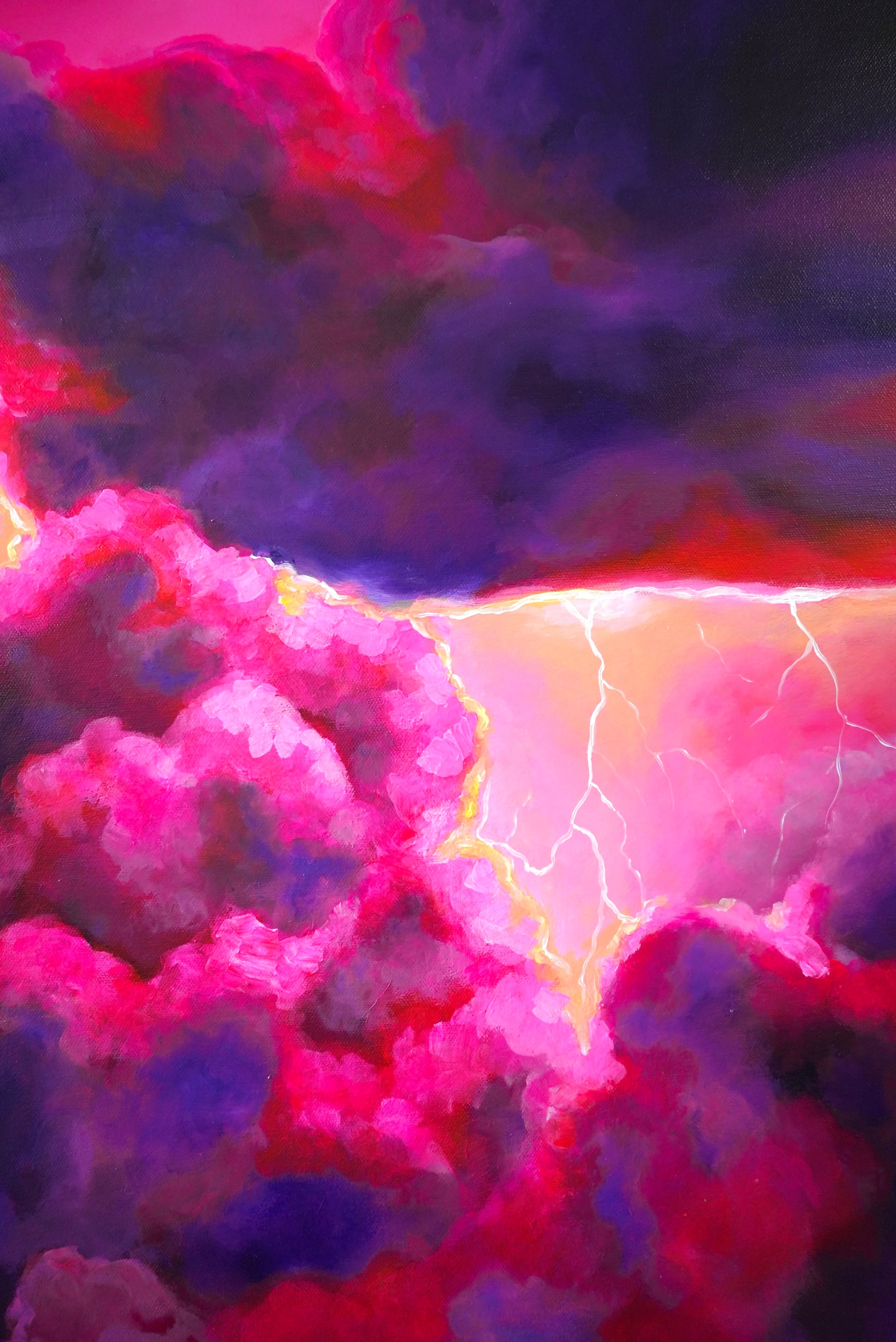 Closeup of colorful cloud formation with lightning in a night sky