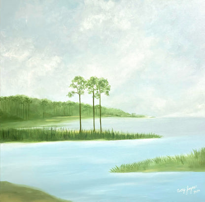 Landscape with two trees by a lake under a cloudy sky